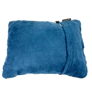 A blue plush throw pillow with a zippered closure, featuring a small black fabric tag on the upper right side that reads 'THEMANTY'. The pillow is photographed from a top-down perspective against a clean, off-white background.