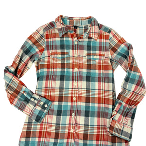 A long-sleeve plaid button-up shirt in red, teal, white, and dark brown, laid flat against a light gray background.