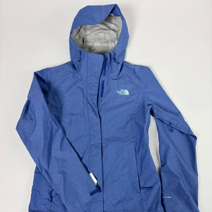 A blue hooded rain jacket from The North Face, laid flat against a light gray background. The jacket features a heathered blue exterior, a light gray interior lining, and the brand's logo on the left chest.